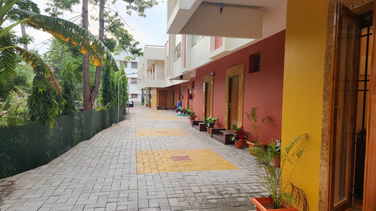 Landscaped internal walkway leading to the rooms at Vishaka INN