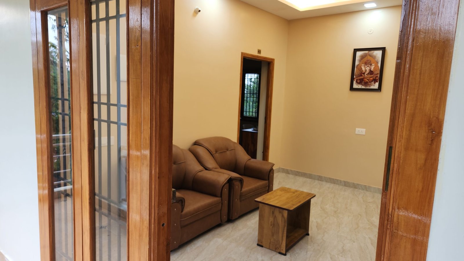 Separate living room with sofa seating in a Vishaka INN suite