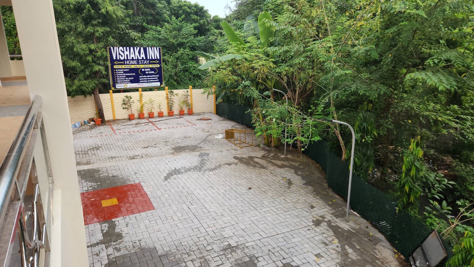 Open paved parking courtyard inside the Vishaka INN premises