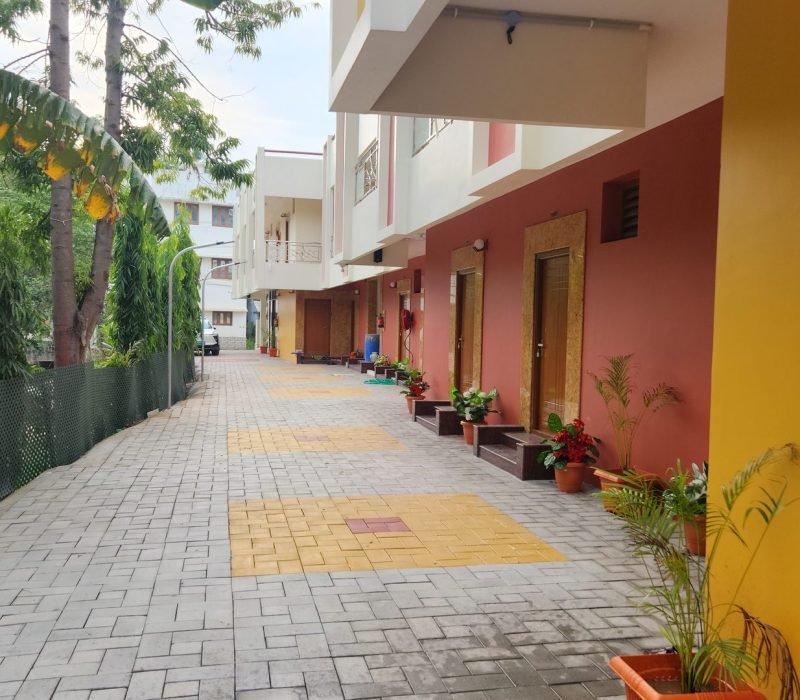 Landscaped internal walkway leading to the rooms at Vishaka INN